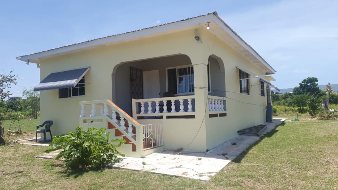 Jab's Retreat — the bungalow's front veranda under a blue Jamaican sky
